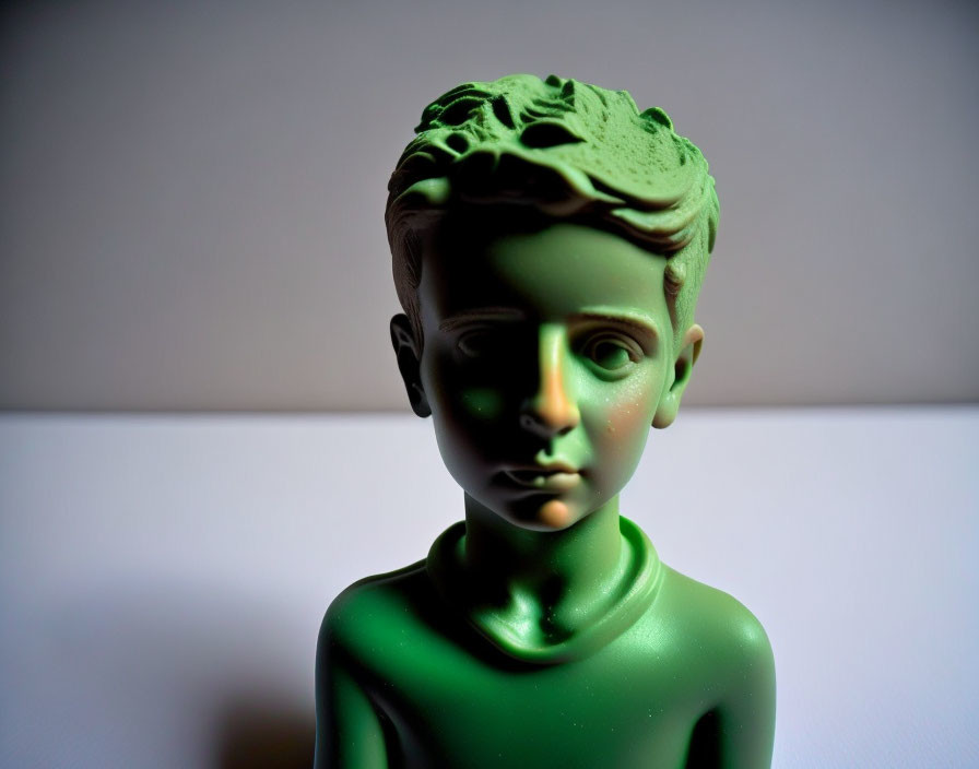 Detailed Green Bust of a Boy with Contrasting Light and Shadow