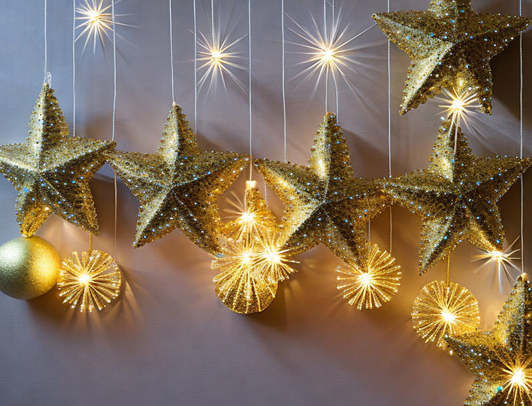 Golden Stars and Orbs with Illuminated Threads on Grey Background