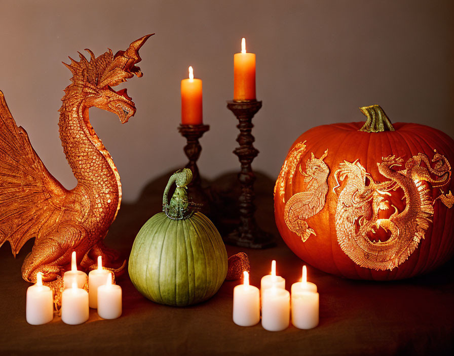 Dragon figurine, carved pumpkin, green gourd, and candles form Halloween display