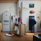 Modern Kitchen with White Cabinets, Black Retro Fridge, Wooden Countertops & Dining Area