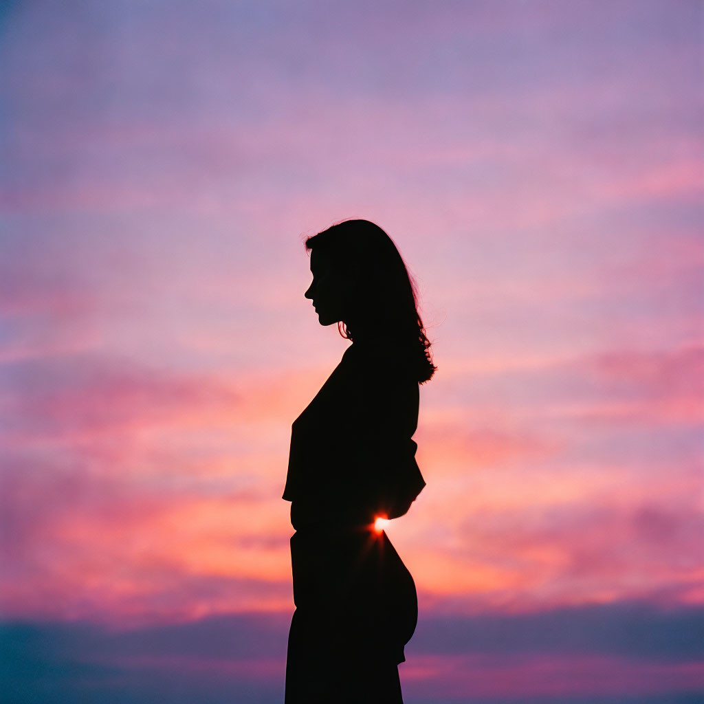 Person's Silhouette Against Vibrant Purple and Pink Sunset Sky