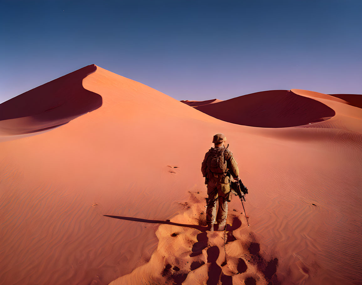 Person in adventure gear on vast desert with orange sand dunes