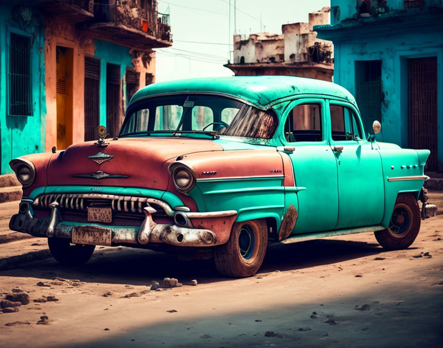 Vintage Turquoise and White Car Parked on Street with Colorful Aged Buildings