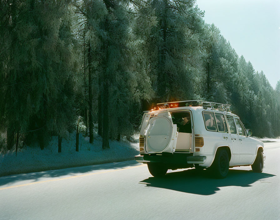 Vintage Station Wagon on Snowy Road with Pine Trees