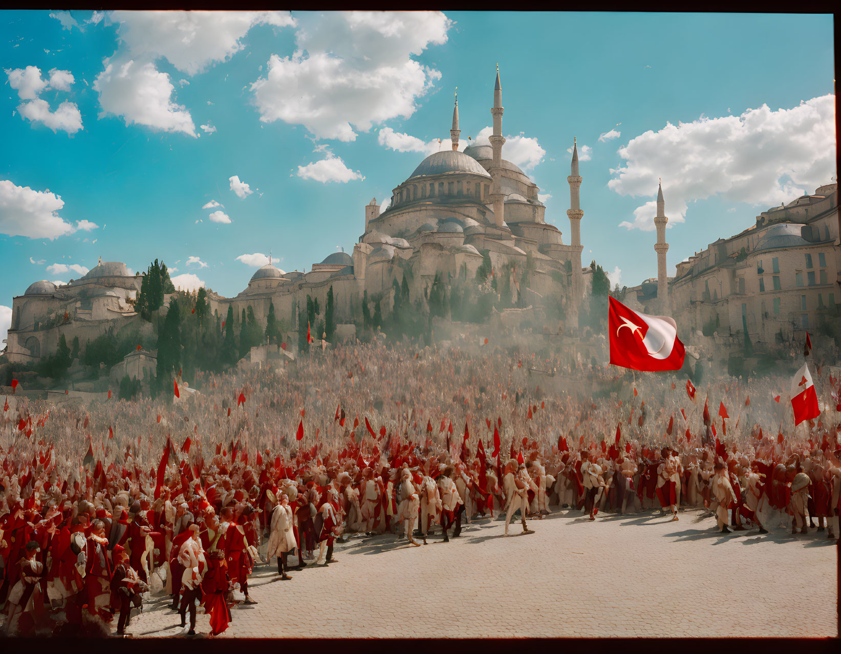 Historical red and white attire crowd with Turkish flags at grand mosque.