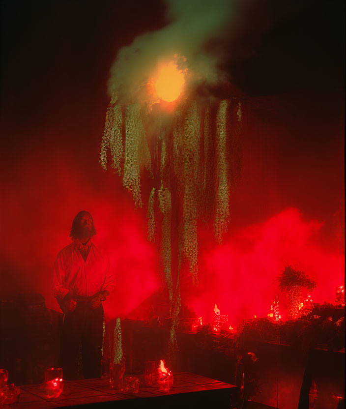 Person in White Shirt Observing Green Glowing Chandelier