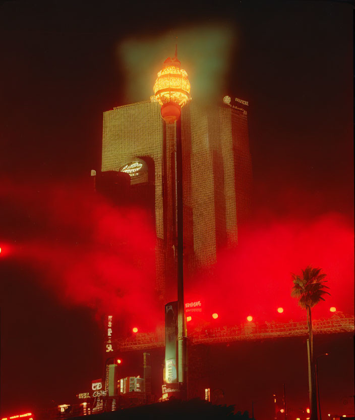 Glowing sphere tower and misty high-rise at night