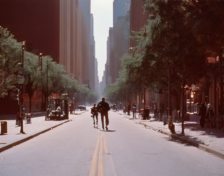 Police officers on horseback patrol sunlit street with tall buildings