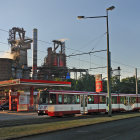 Steampunk-style train on tracks in vintage industrial setting