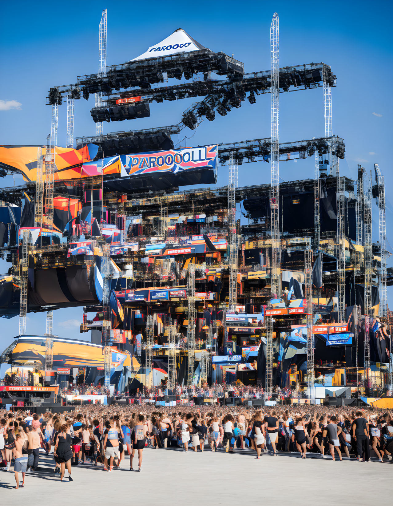 Crowd in Summer Attire at Elaborate Outdoor Stage