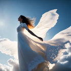 Elegant Bride in White Lace Dress Backlit Against Blue Sky