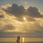 Sunset beach scene with two people, waves, clouds, and birds