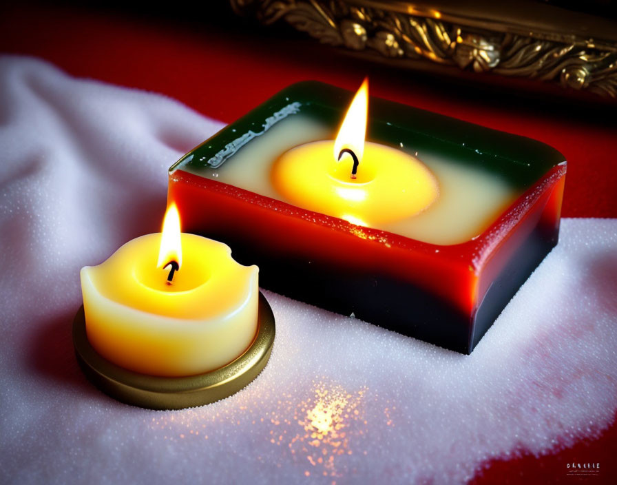 Star and square-shaped candles on white fabric with red backdrop