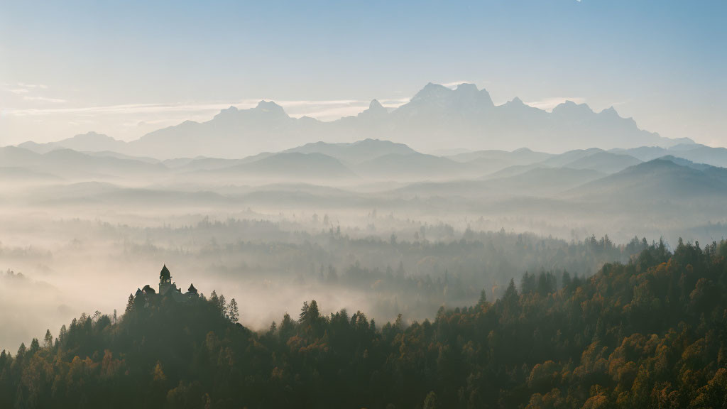 Misty layered hills, forest, mountain peaks under clear sky