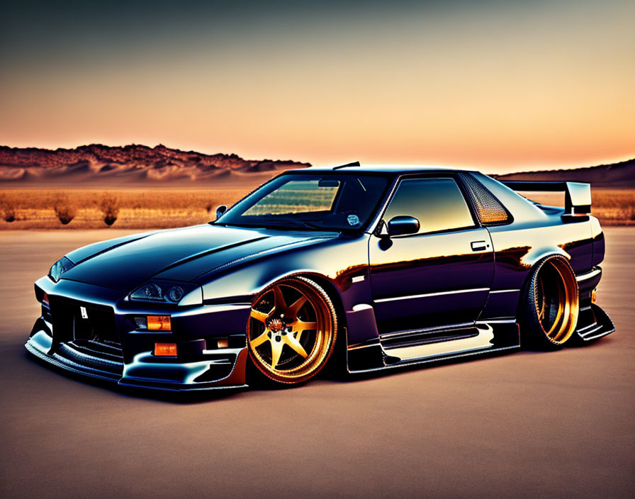 Black Sports Car with Gold Rims Parked Against Orange Horizon