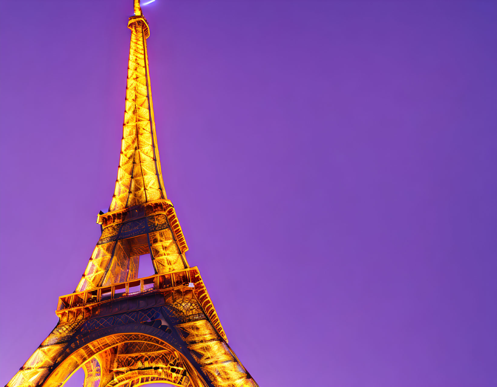 Iconic Eiffel Tower at Night with Purple Sky