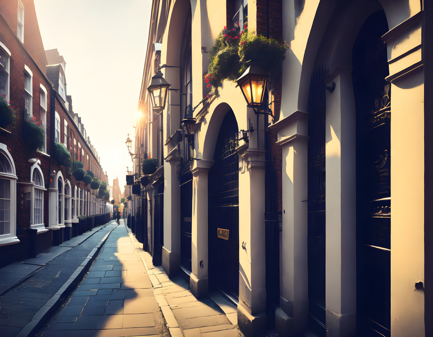 Charming sunrise scene: row houses, arched doorways, flower baskets, vintage street lamps