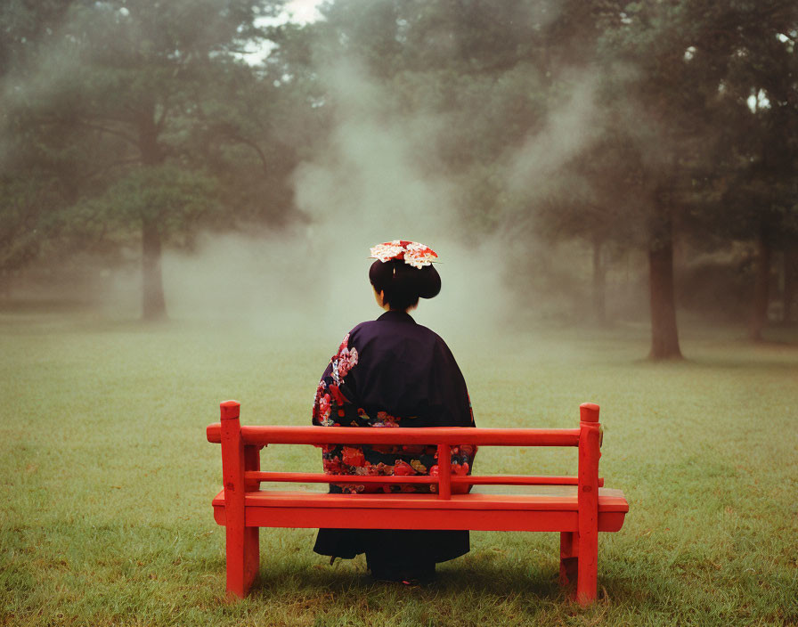 Traditional Japanese Attire Figure on Red Bench in Misty Setting