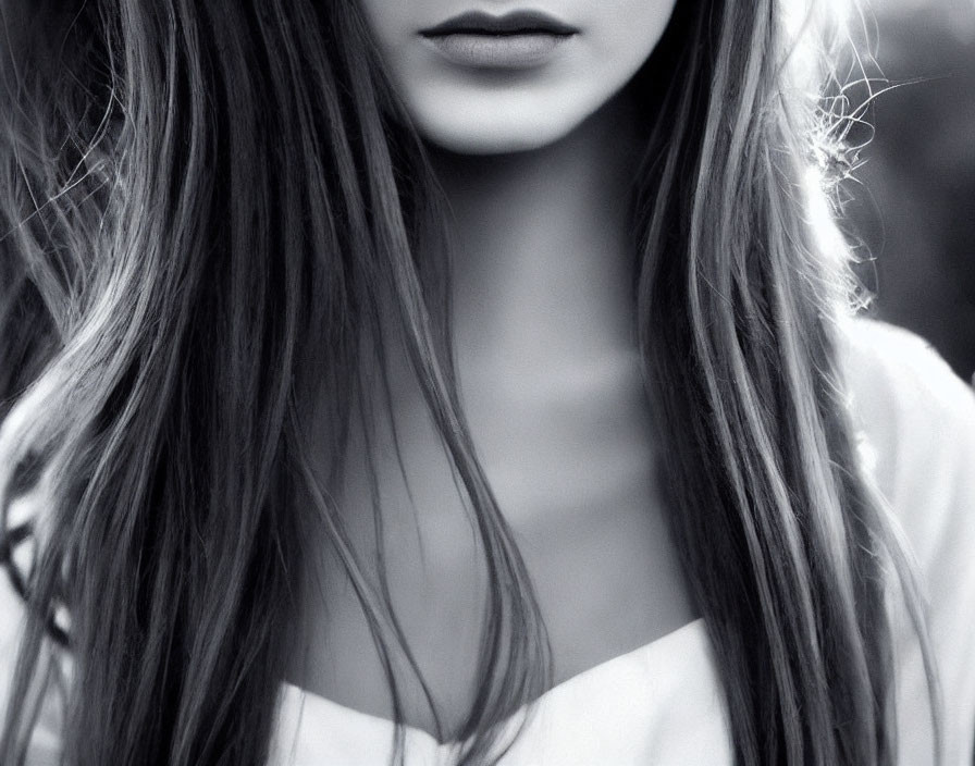 Monochrome close-up of woman with long hair and lips.