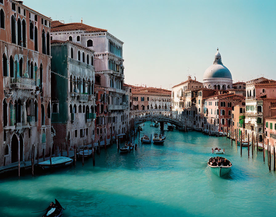 Grand Canal in Venice with gondolas and historic buildings on clear day