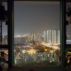 Futuristic cityscape at night with high-rise buildings and old architecture under starry sky