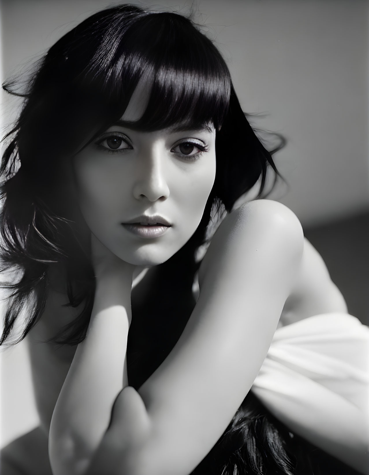 Monochrome portrait of woman with dark hair and bangs