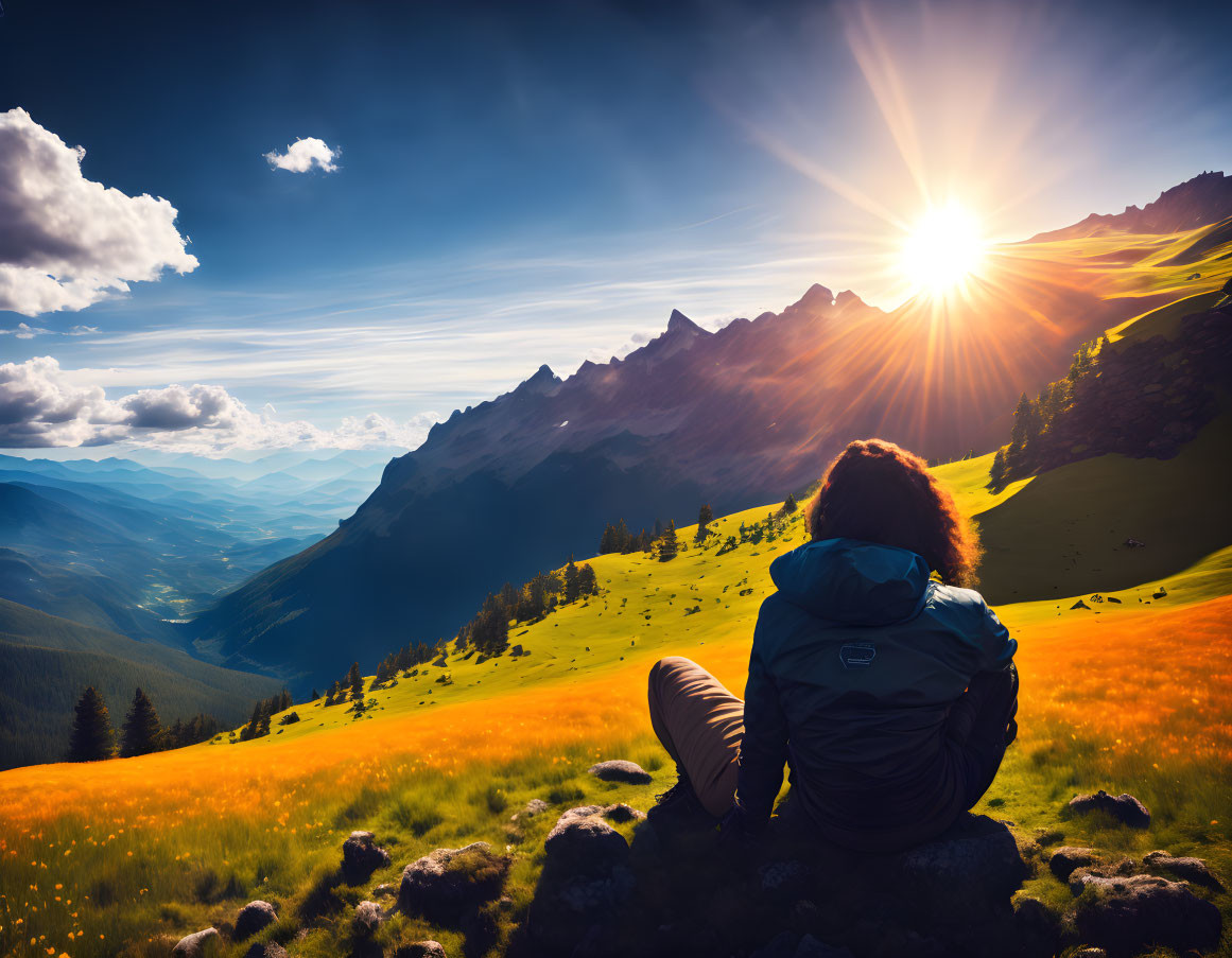 Person enjoying mountain vista at sunset with green meadows and blue sky