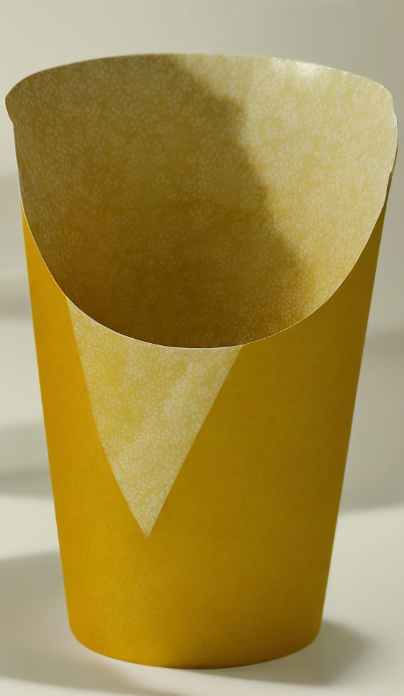 Yellow Textured Paper Cone on Light Background