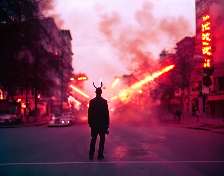 Mysterious figure in horned mask on foggy city street at dusk