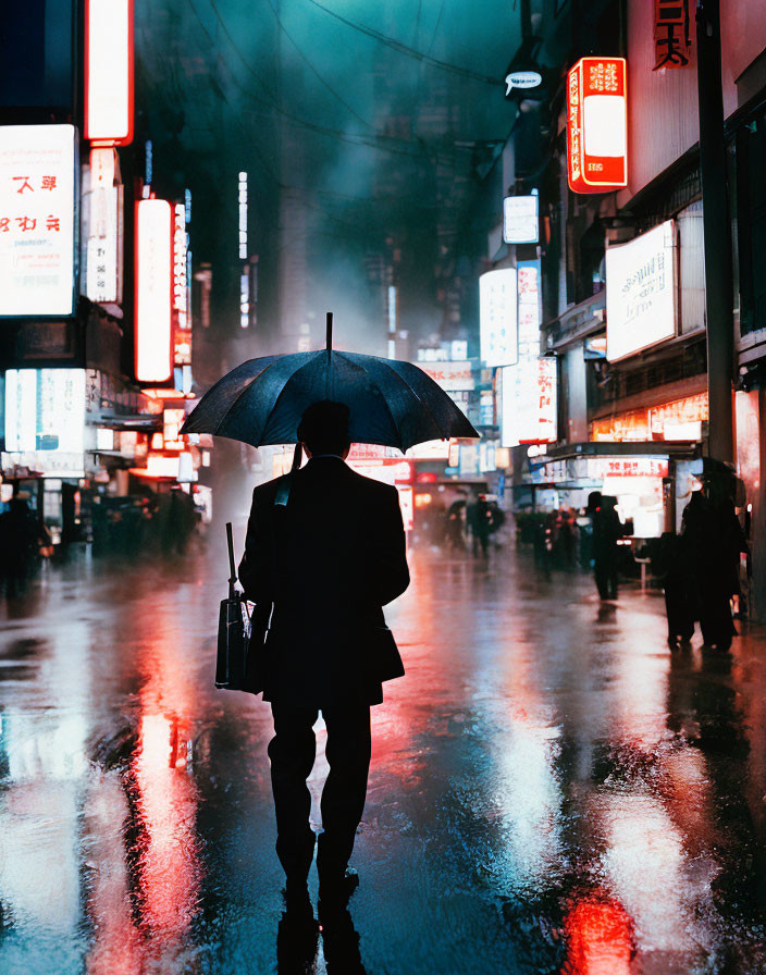 Person with umbrella on rain-soaked street under vibrant neon signs at night