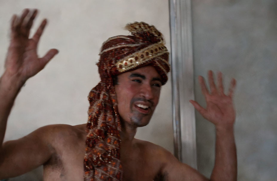 Smiling man in turban gesturing with hands