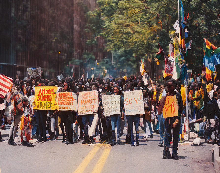 Protesters marching with signs and flags on street