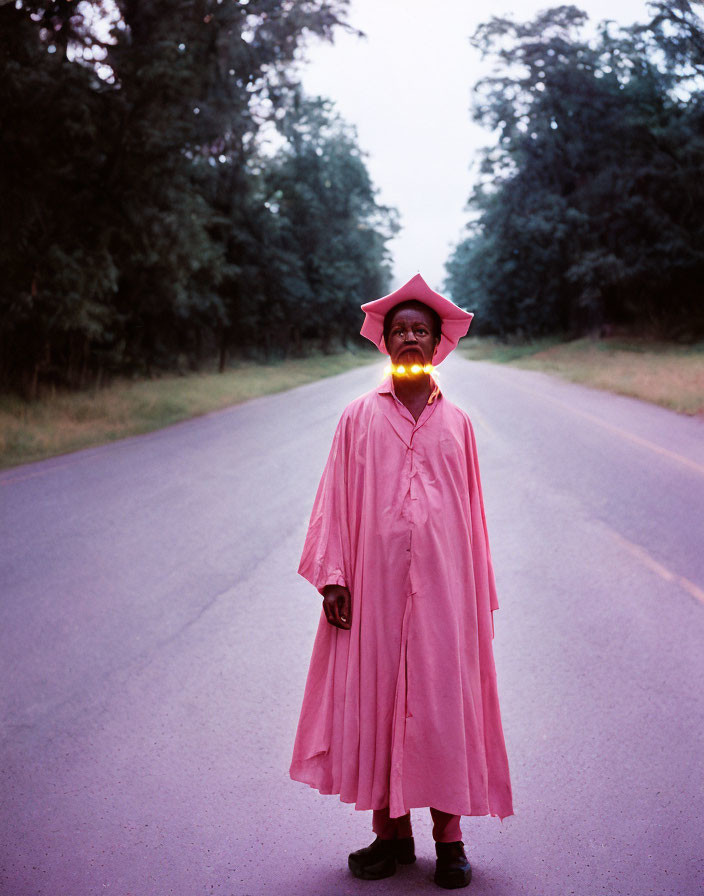 Graduate in Pink Gown Glowing Mouth on Road