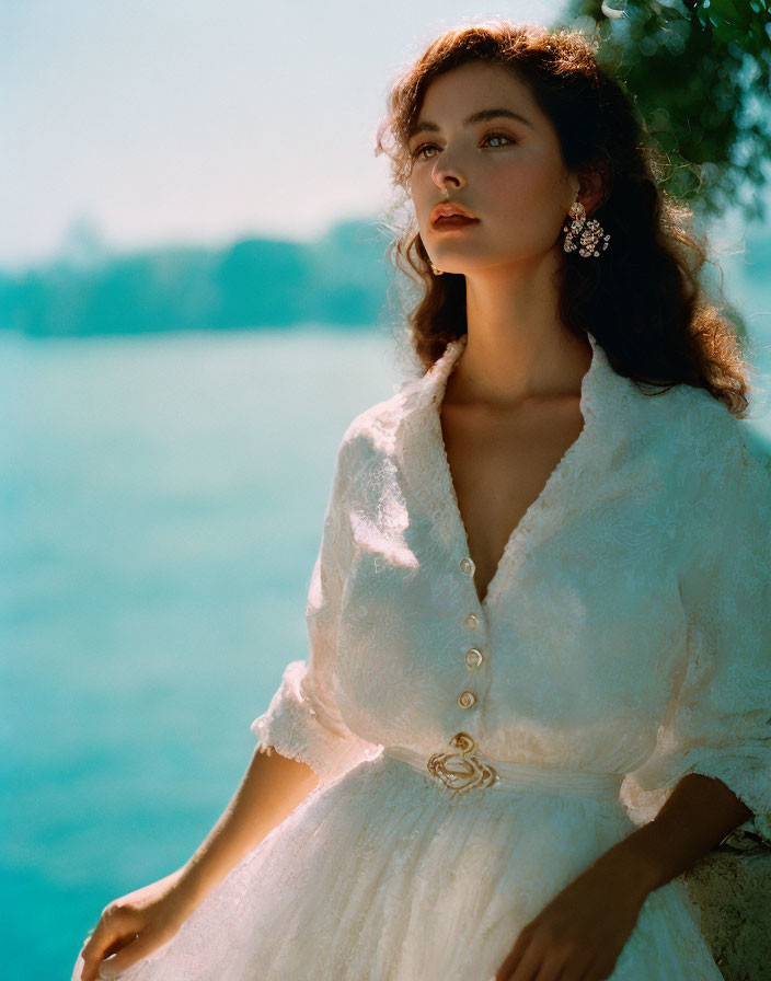 Vintage White Dress Woman Poses by Blue Water