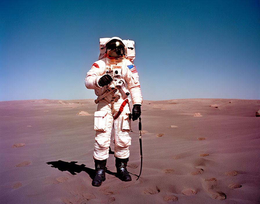 Astronaut in white space suit on barren desert landscape