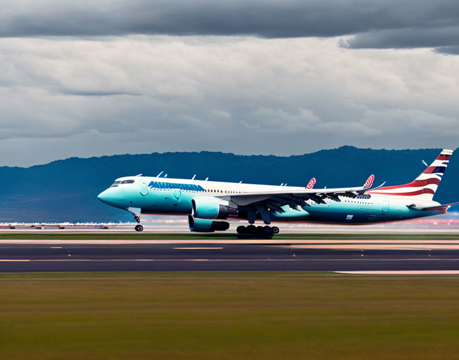 Commercial airplane landing on runway under dark clouds.