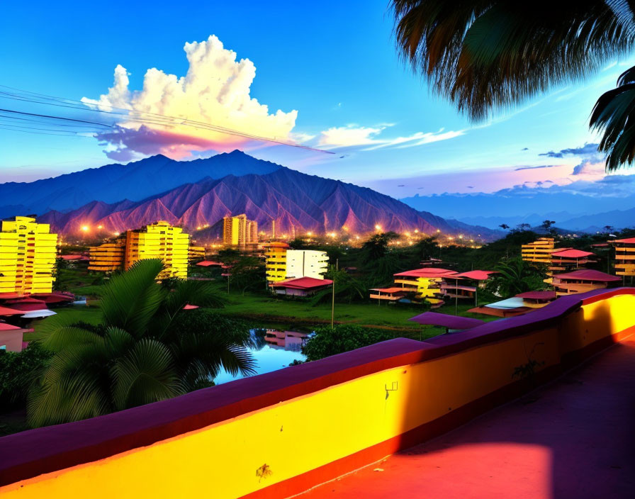 Tropical cityscape at twilight with illuminated buildings and mountains in the background