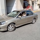 Metallic Bronze Sedan Car Parked with Shiny Rims on Sunny Day