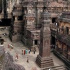 Colorful Multi-Tiered Temple with Gold Accents in Rocky Terrain