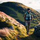 Hiker with backpack in lush, hilly landscape under cloudy sky