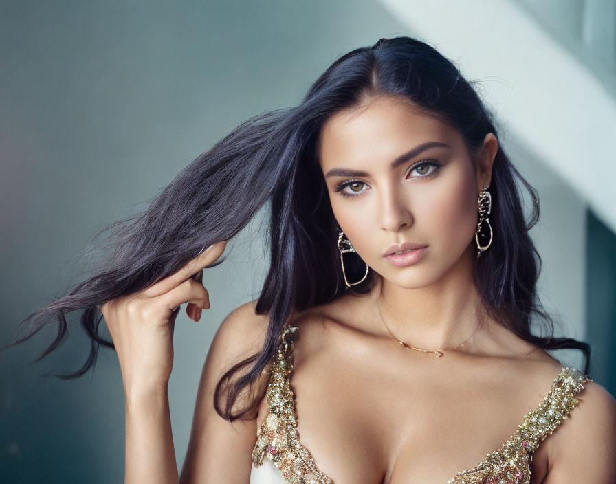 Woman with Long Dark Hair in Gold Dress and Jewelry