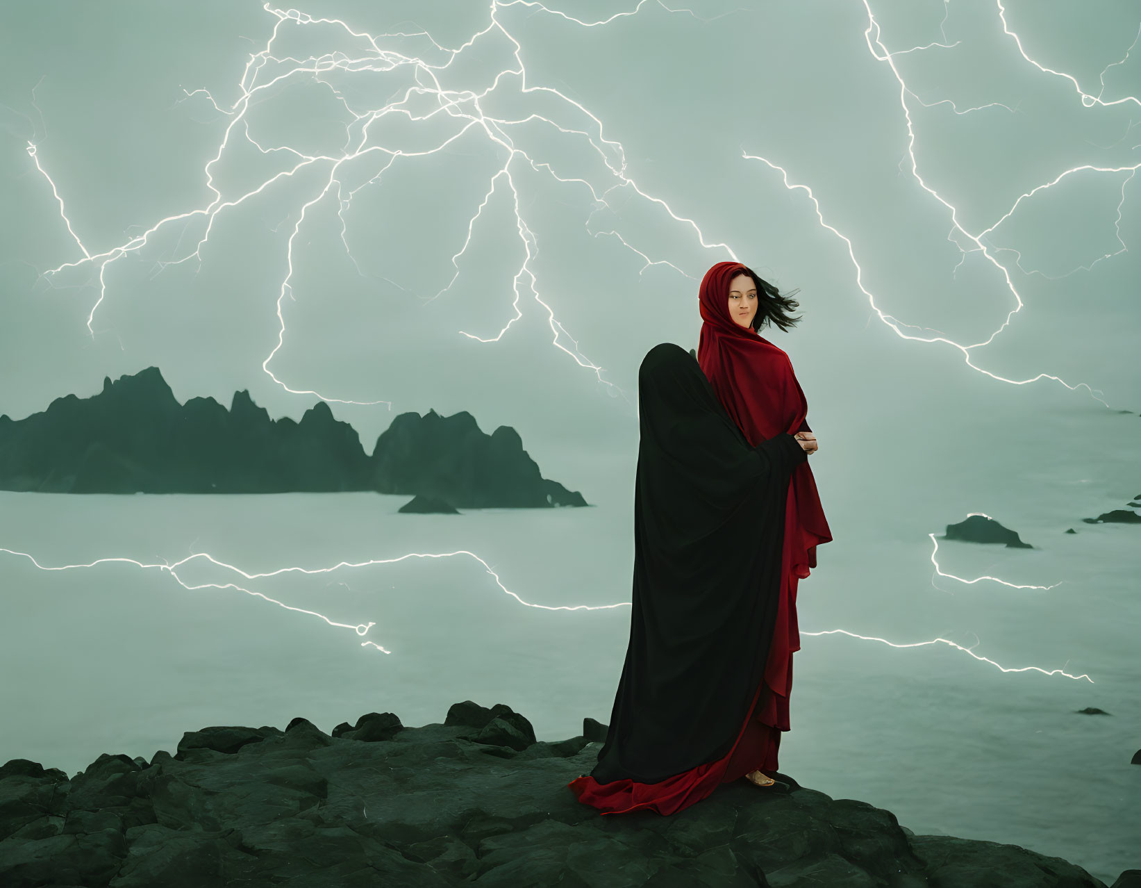 Person in Red Cloak on Rocky Terrain with Lightning Striking Turbulent Seas