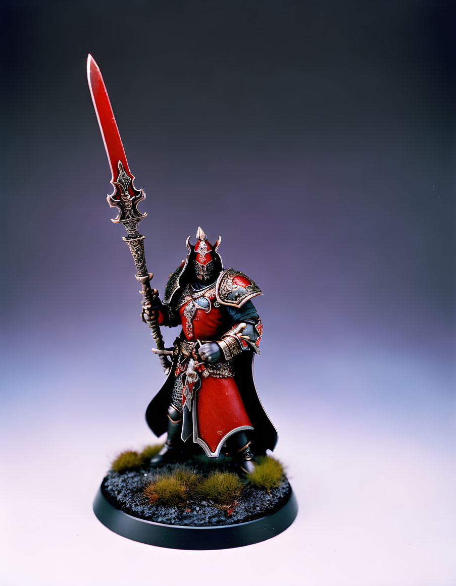 Detailed Miniature Knight Figurine in Red and Black Armor with Long Sword on Grass-like Base