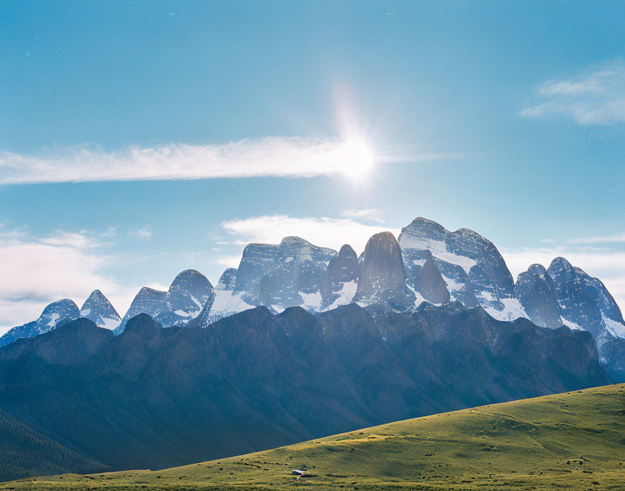 Majestic snow-capped mountain range bathed in sunlight