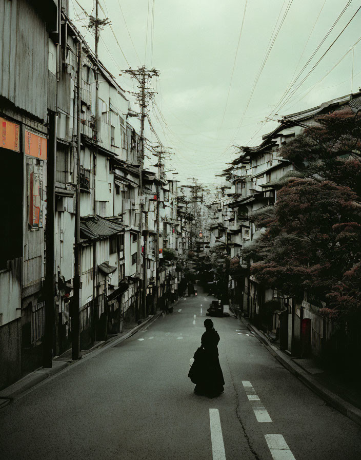 Solitary Figure Walking Down Narrow Street Amid Old Buildings