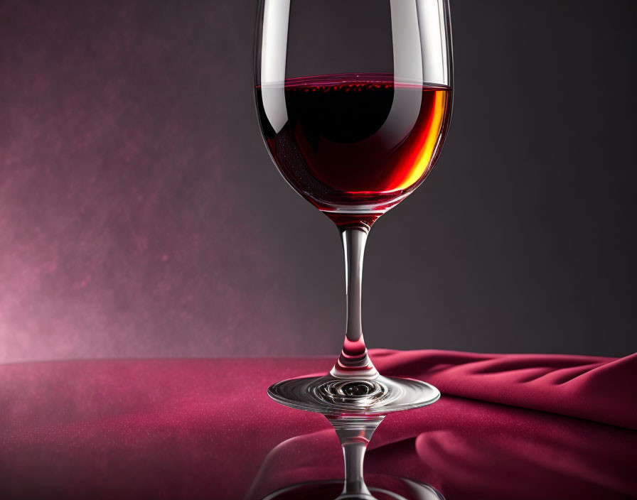 Red Wine Glass on Reflective Surface with Purple Fabric Backdrop