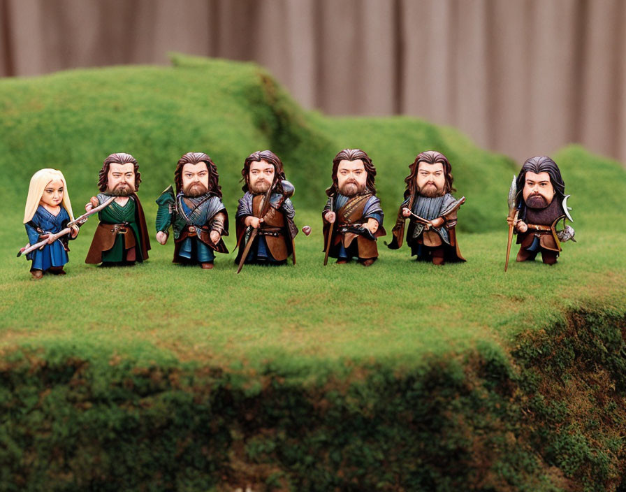 Seven Fantasy-Themed Warrior and Elf Figurines on Grass Against Natural Landscape