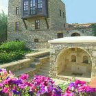 Enchanting fairy-tale cottage with thatched roof and flowering vines