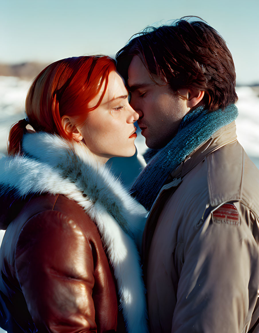 Affectionate couple with foreheads touching in snowy landscape