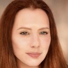 Portrait of Woman with Red Hair, Fair Skin, and Green Eyes in Close-Up Shot